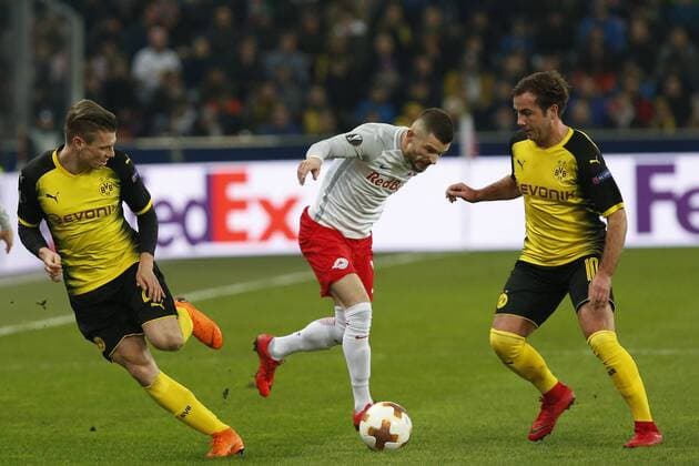 UEFA Europa League vs. Borussia Dortmund Lukasz Piszczek Borussia Dortmund Valon Berisha FC Salzburg and Mario Goetze Borussia Dortmund at the UEFA Europa League Salzburg vs Borussia Dortmund on March 15 2018 in Salzburg Austria xD. G.x