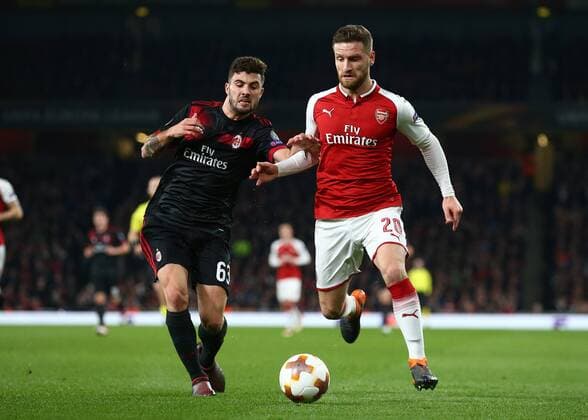 15th March 2018, Emirates Stadium, London, England; UEFA Europa League football, round of 16 second leg, Arsenal versus AC Milan; Patrick Cutrone of AC Milan puts pressure on Shkodran Mustafi of Arsenal  ActionPlus12001820