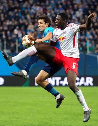 ST PETERSBURG, RUSSIA - MARCH 15, 2018: RB Leipzig s Ibrahima Konate (front) and Zenit St Petersburg s Yuri Zhirkov in action in their 2017-2018 UEFA Europa League Round of 16 second leg football match at Saint Petersburg Stadium. The game ended in a 1-1 draw. Alexander Demianchuk TASS  TS077E78