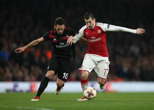 15th March 2018, Emirates Stadium, London, England; UEFA Europa League football, round of 16 second leg, Arsenal versus AC Milan; Hakan Calhanoglu of AC Milan and Henrikh Mkhitaryan of Arsenal compete for the ball  ActionPlus12001850