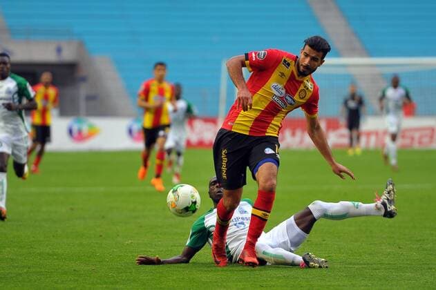 Haithem Jouini(14) and Onyango Joash(12) during the match Esperance Sportive de Tunis who validated his ticket to the group phase of the African Champions League after a short victory of (1-0) face Gor Mahia Kenyan club in the second leg of the final of the competition sixteenths played at Rades stadium. African Champions League:EST vs Gor Mahia. 