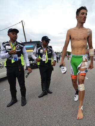 March 23, 2018 - Tanjung Malim, Malaysia - Luca Wackermann from BardianiÃ¢â‚¬CSF Team walks near the finish line of the sixth stage, as he got involved into a crash during the final part of Tapah to Tanjung Malim stage, of the 2018 Le Tour de Langkawi. .On Friday, March 23, 2018, in Tanjung Malim, Malaysia. Le Tour de Langkawi 2018 - Stage 6  - ZUMAn230 20180323_zaa_n230_032 Copyright: xArturxWidakx