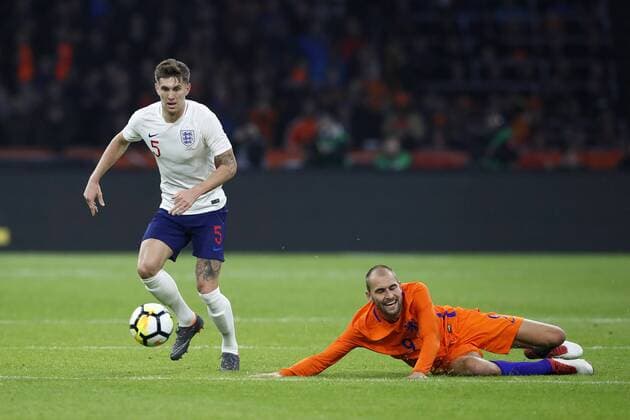 Netherland s Bas Dost tussles with England s John Stones during the International Friendly Länderspiel match at the Amsterdam Arena, Amsterdam. Picture date: March 23rd 2018. Picture credit should read: David Klein Sportimage EDITORIAL USE ONLY. No use with unauthorised audio, video, data, fixture lists, club league logos or live services. Online in-match use limited to 120 images, no video emulation. No use in betting, games or single club league player publications.