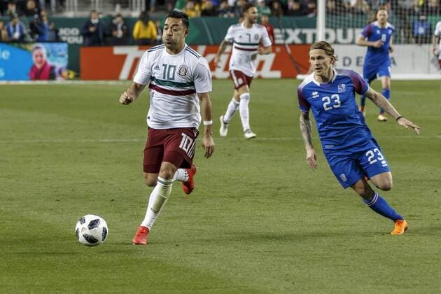 SANTA CLARA, CA - MARCH 23:Mexico Midfielder Marco Fabian (10) attacks as Iceland Defender Kari Arnason (23) pursues during the second half of the international match Länderspiel between Mexico and Iceland on Friday, March 23, 2018 at Levi s Stadium in Santa Clara, CA. Final Score: Mexico-3, Iceland-0. (Photo by Allan Hamilton Icon Sportswire) SOCCER: MAR 23 Mexico v Iceland Icon18032321 EDITORIAL USE ONLY