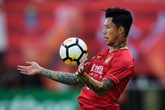 --FILE--Chinese soccer player Zhang Linpeng of Guangzhou Evergrande Taobao F.C. holds the ball on the chest in a match during the 2018 Chinese Football Association Super League (CSL) in Guangzhou city, south China s Guangdong province, 14 February 2018. Chinese soccer players might have been ordered to conceal their tattoos, media reported, after China s national team Nationalteam players were seen covering them at televised matches. The Chinese Football Association will issue regulations on tattoos for the Chinese Super League and other national team matches, news site thepaper.cn reported Sunday (25 March 2018). Players were spotted covering their tattoos with tape during the games of China s U23 national team against Syria on Saturday and national team Wales on Thursday, thepaper.cn reported. However, covering tattoos seemed to hardly change the fate of the Chinese team, which lost to Wales, 0-6. Chinese Football Association to ban tattoo from players: report  20180214_12396