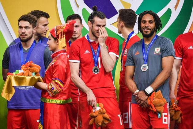 First runner-up Wales national football team take part in the award ceremony after being defeated by Uruguay national football team in their final match during the 2018 Gree China Cup International Football Championship in Nanning city, south China s Guangxi Zhuang Autonomous Region, 26 March 2018. Uruguay won the final by 1-0 against Wales and claimed the title of the event. Uruguay claims title of 2018 China Cup Int l Football Championship in Nanning  20180326_53360
