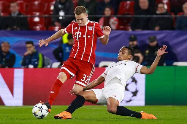 3rd April 2018, Ramon Sanchez Pizjuan, Seville, Spain; UEFA Champions League football, quarter final 1st leg, Sevilla versus Bayern Munich; Luis Muriel of Sevilla FC tackles Kimmich of Bayern Munich  ActionPlus12008225