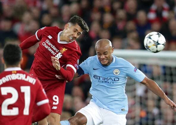 4th April 2018, Anfield, Liverpool, England; UEFA Champions League football, quarter final 1st leg, Liverpool versus Manchester City; Roberto Firmino of Liverpool beats Vincent Kompany of Manchester City in the air  ActionPlus12008365