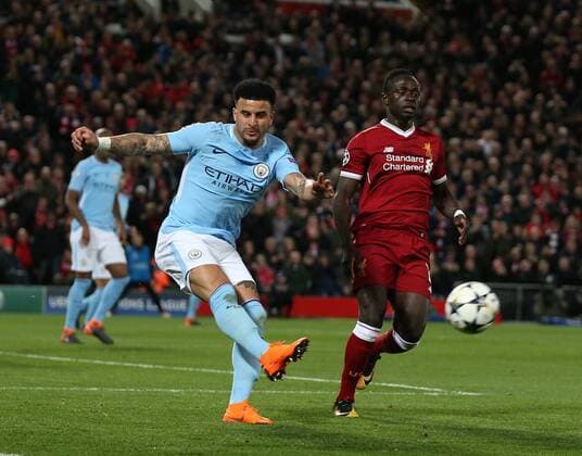 Kyle Walker of Manchester City clears under pressure from Sadio Mane of Liverpool during the Champions League Quarter Final 1st Leg, match at Anfield Stadium, Liverpool. Picture date: 4th April 2018. Picture credit should read: Simon Bellis Sportimage EDITORIAL USE ONLY. No use with unauthorised audio, video, data, fixture lists, club league logos or live services. Online in-match use limited to 120 images, no video emulation. No use in betting, games or single club league player publications.