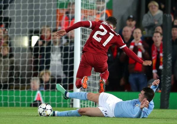 4th April 2018, Anfield, Liverpool, England; UEFA Champions League football, quarter final 1st leg, Liverpool versus Manchester City; Alex Oxlade-Chamberlain of Liverpool slide tackled by Aymeric Laporte of Manchester City  ActionPlus12008377