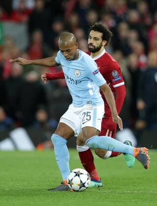 4th April 2018, Anfield, Liverpool, England; UEFA Champions League football, quarter final 1st leg, Liverpool versus Manchester City; Fernandinho of Manchester City passes across midfield as Mohammed Salah of Liverpool presses  ActionPlus12008381