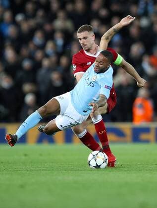 Football - 2017 2018 UEFA Champions League - Quarter-Final, First Leg: Liverpool vs. Manchester City Jordan Henderson of Liverpool is booked for this tackle on Raheem Sterling of Manchester City at Anfield. COLORSPORT LYNNE CAMERON 