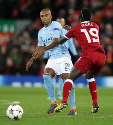 4th April 2018, Anfield, Liverpool, England; UEFA Champions League football, quarter final 1st leg, Liverpool versus Manchester City; Fernandinho of Manchester City threads the ball forward as Sadio Mane of Liverpool makes a challenge  ActionPlus12008554