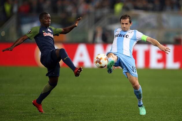 5th April 2018, Stadio Olimpico, Rome, Italy; UEFA Europa League football, quarter final, 1st leg, Lazio versus FC Salzburg; (L-R) Amadou Haidara of Salzburg challenges Senad Lulic of Lazio  ActionPlus12009023
