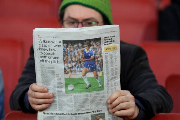 5th April 2018, Emirates Stadium, London, England; UEFA Europa League football, quarter final, 1st leg, A fan reads a newspaper with the back page showing an article about Ray Wilkins  ActionPlus12009073