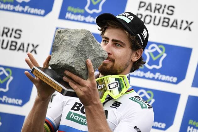 Slovakian Peter Sagan of Bora-Hansgrohe celebrates on the podium with the cobblestone trophy after winning the 116th edition of the Paris-Roubaix one day cycling race, from Compiegne, near Paris to Roubaix. YORICKxJANSENS  x05326165x