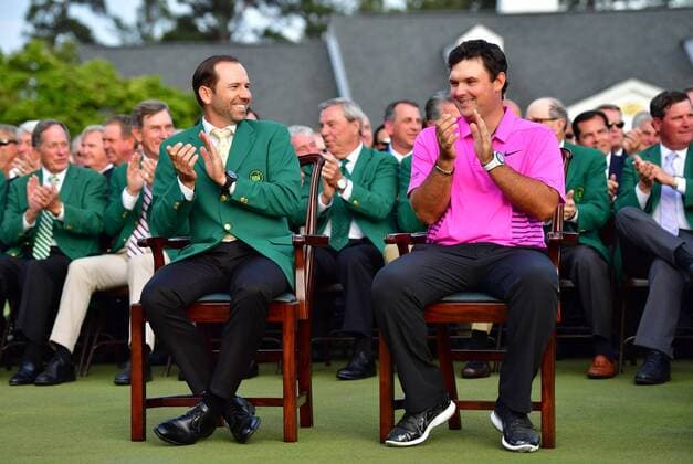 Patrick Reed (R) and 2017 champion Sergio Garcia applaud during the green jacket ceremony after Reed won the 2018 Masters Tournament at the Augusta National Golf Club in Augusta, Georgia, on April 8, 2018. Reed wins his first major and the 2018 Masters with a score of 15-under-par.  AUG20180408326 KEVINxDIETSCH