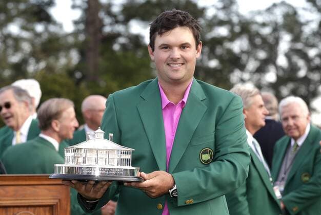 Patrick Reed wears his Green Jacket and holds the Masters Trophy after the final round of the 2018 Masters Tournament at the Augusta National Golf Club in Augusta, Georgia, on April 8, 2018. Reed wins his first major and the 2018 Masters with a score of 15 under par.  AUG20180408140 JOHNxANGELILLO