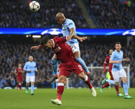 10th April 2018, Etihad Stadium, Manchester, England; UEFA Champions League football, quarter final, second leg; Manchester City verses Liverpool; Fernandinho of Manchester City climbs over Roberto Firmino of Liverpool  ActionPlus12011647