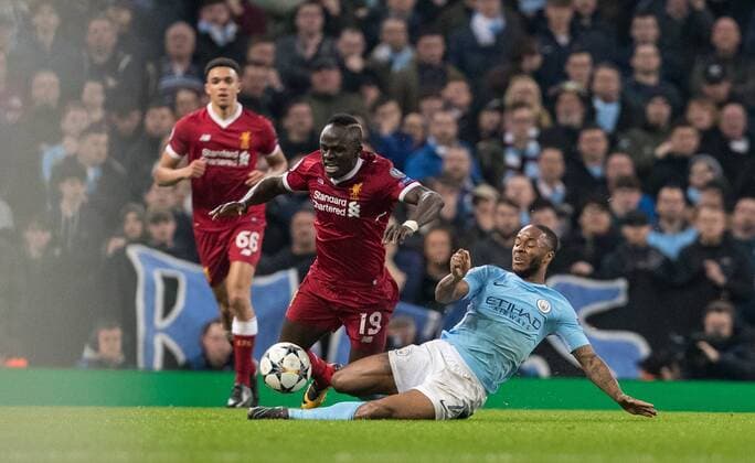 Raheem Sterling of Man City tackles Sadio Mane of Liverpool during the UEFA Champions League QF 2nd leg match between Manchester City and Liverpool at the Etihad Stadium, Manchester, England on 10 April 2018. Copyright: xAndyxRowlandx PMI-1960-0005