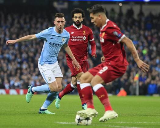 10th April 2018, Etihad Stadium, Manchester, England; UEFA Champions League football, quarter final, second leg; Manchester City verses Liverpool; Mohamed Salah of Liverpool and Aymeric Laporte of Manchester City watch Roberto Firmino of Liverpool control the ball  ActionPlus12011830
