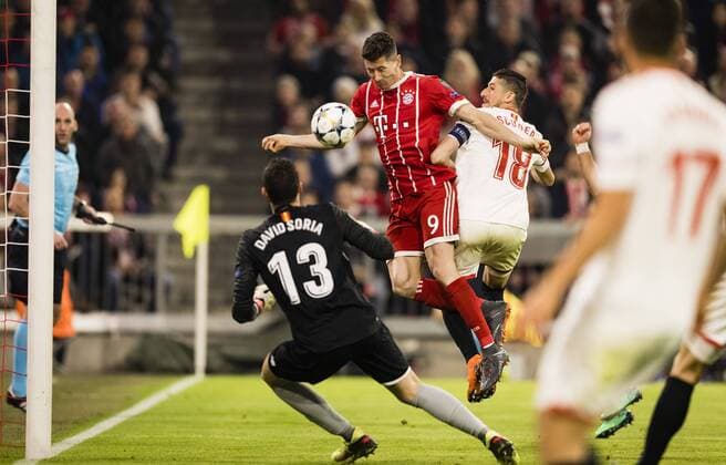 Munich 11 04 2018 Robert Lewandowski FCB defeated Sergio Escudero Sevilla with goalkeeper David Soria Sevilla FC Bayern Munich FC Sevilla