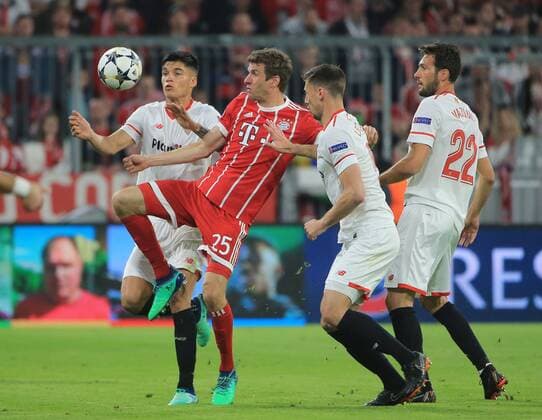 (180412) -- MUNICH, April 12, 2018 -- Bayern Munich s Thomas Mueller (2nd L) vies with Sevilla s Joaquin Correa (1st L), Clement Lenglet (2nd R) and Franco Vazquez during the UEFA Champions League quarterfinal second leg soccer match between Bayern Munich of Germany and FC Sevilla of Spain in Munich, Germany, on April 11, 2018. The match ended 0-0 and Bayern Munich advanced to the semifinal with 2-1 on aggregate. ) (SP)GERMANY-MUNICH-SOCCER-UEFA CHAMPIONS LEAGUE-BAYERN MUNICH-SEVILLA PhilippexRuiz 