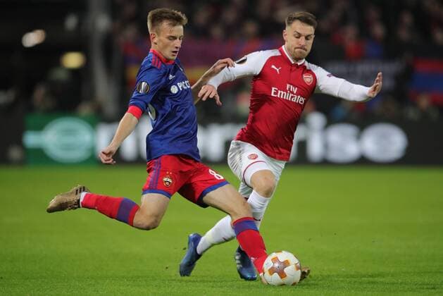 MOSCOW, RUSSIA - APRIL 12, 2018: CSKA Moscow s Konstantin Kuchayev (L) and Arsenal F.C. s Aaron Ramsey fight for the ball in their 2017-2018 UEFA Europa League quarterfinal second leg football match at VEB Arena (Arena CSKA). Sergei Bobylev TASS  TS07BA32