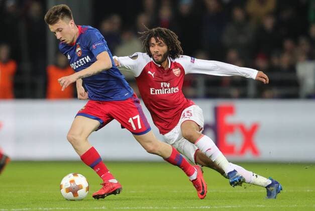 MOSCOW, RUSSIA - APRIL 12, 2018: CSKA Moscow s Alexander Golovin (L) and Arsenal F.C. s Mohamed Elneny fight for the ball in their 2017-2018 UEFA Europa League quarterfinal second leg football match at VEB Arena (Arena CSKA). Sergei Bobylev TASS  TS07BA37