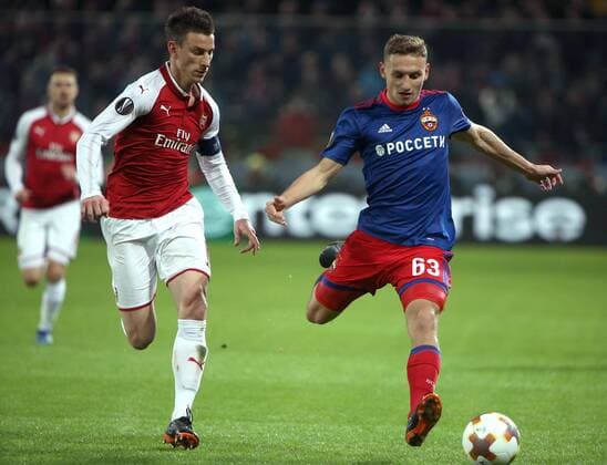 MOSCOW, RUSSIA - APRIL 12, 2018: Arsenal F.C. s Laurent Koscielny (L) and CSKA Moscow s Fyodor Chalov fight for the ball in their 2017-2018 UEFA Europa League quarterfinal second leg football match at VEB Arena (Arena CSKA). The game ended in a 2-2 draw. Mikhail Tereshchenko TASS  TS07BA5B