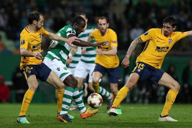 April 12, 2018 - Lisbon, Portugal - Sporting s forward Seydou Doumbia from Ivory Coast (C ) vies with Atletico Madrids defenders Juanfran of Spain (L) and Stefan Savic of Montenegro (R ) during the UEFA Europa League second leg football match Sporting CP vs Atletico Madrid at Alvalade stadium in Lisbon, on April 12, 2018. Sporting v Atletico Madrid - UEFA Europa League Quarter Final Leg Two  - ZUMAn230 20180412_zaa_n230_1030 Copyright: xPedroxFiuzax
