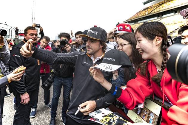 Spanish F1 driver Fernando Alonso of McLaren poses for selfies with fans at the Shanghai International Circuit before the 2018 Formula 1 Chinese Grand Prix in Shanghai, China, 12 April 2018. F1 drivers wow fans with signatures and selfies in Shanghai  20180412_14153