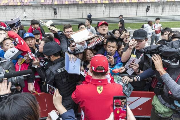 Finnish F1 driver Kimi Raikkonen of Ferrari signs autographs for fans at the Shanghai International Circuit before the 2018 Formula 1 Chinese Grand Prix in Shanghai, China, 12 April 2018. F1 drivers wow fans with signatures and selfies in Shanghai  20180412_61331
