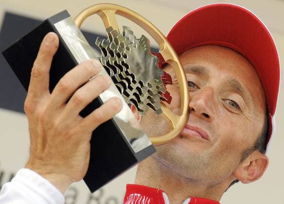 - HUY, BELGIUM: Italian Davide Rebellin of Serramenti-PVC-Diquigiovanni cycling team, celebrates on the podium after he won for the third time the one day cycling race Fleche Wallonne, in Huy, Wednesday 22 April 2009. BENOITxDOPPAGNE  x13511334x