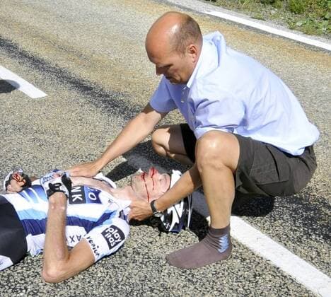 - BOURG-SAINT-MAURICE, FRANCE: Manger of the Saxo Bank team Bjarne Riis assists German cyclist Jens Voigt after a crash in a downhill of the 16th stage of the Tour de France cycling race, from Montigny (Switzerland) to Bourg-Saint-Maurice (France) (160km), Tuesday 21 July 2009. BENOITxDOPPAGNE  x14677252x