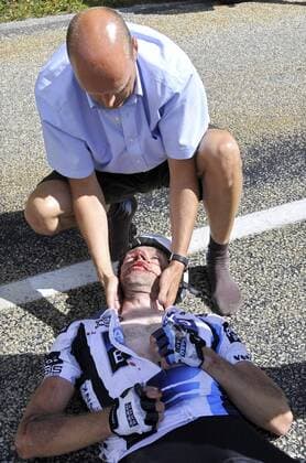 - BOURG-SAINT-MAURICE, FRANCE: Manager of the Saxo Bank team Bjarne Riis assists German cyclist Jens Voigt after a crash in a downhill of the 16th stage of the Tour de France cycling race, from Montigny (Switzerland) to Bourg-Saint-Maurice (France) (160km), Tuesday 21 July 2009. BENOITxDOPPAGNE  x14677488x