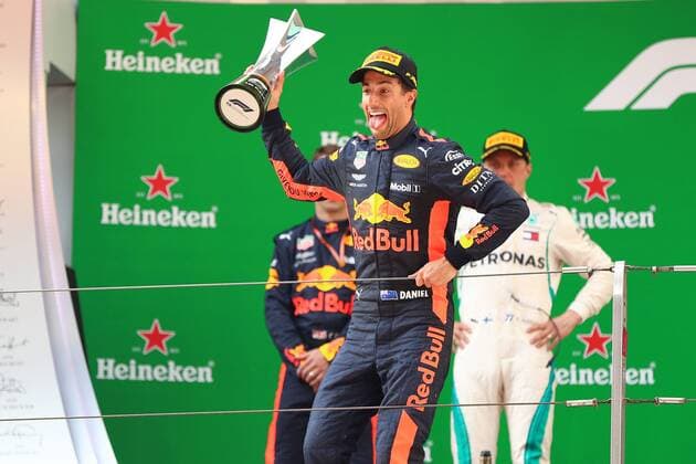 Australian F1 driver Daniel Ricciardo of Red Bull Racing holds up his trophy to celebrate on the podium after winning the 2018 Formula One Chinese Grand Prix at the Shanghai International Circuit in Shanghai, China, 15 April 2018. Daniel Ricciardo charged from sixth to score a stunning first win of the 2018 Formula 1 season as Max Verstappen and Sebastian Vettel collided in a wild Chinese Grand Prix. Bottas and Vettel were locked in their own battle for the win until Ricciardo and Verstappen pitted again for fresh, soft tyres during a safety car period just after the halfway mark as their rivals stayed on mediums. Ricciardo then overtook his team-mate, Lewis Hamilton and Vettel in quick succession before executing a stunning pass on Bottas into the tight Turn 6 right-hander for the victory. Daniel Ricciardo storms to Chinese Grand Prix victory for Red Bull 