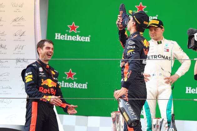 Australian F1 driver Daniel Ricciardo of Red Bull Racing drinks champagne out of his shoe on the podium after winning the 2018 Formula One Chinese Grand Prix at the Shanghai International Circuit in Shanghai, China, 15 April 2018. Daniel Ricciardo charged from sixth to score a stunning first win of the 2018 Formula 1 season as Max Verstappen and Sebastian Vettel collided in a wild Chinese Grand Prix. Bottas and Vettel were locked in their own battle for the win until Ricciardo and Verstappen pitted again for fresh, soft tyres during a safety car period just after the halfway mark as their rivals stayed on mediums. Ricciardo then overtook his team-mate, Lewis Hamilton and Vettel in quick succession before executing a stunning pass on Bottas into the tight Turn 6 right-hander for the victory. Daniel Ricciardo storms to Chinese Grand Prix victory for Red Bull 