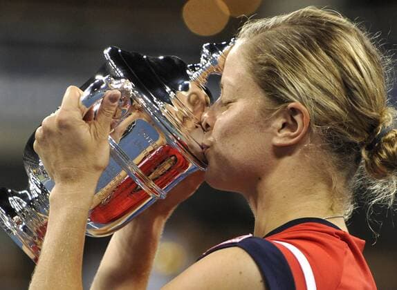 - NEW YORK, USA : Belgian tennis player Kim Clijsters, kisses the trophy during the ceremony after she won 7-5, 6-3 the US Open final match against Caroline Wozniaki of Denmark, at the US Open Grand Slam Tennis tournament, at Flushing Meadows, in New York, Sunday 13 September 2009. Clijsters won a Grand Slam title just one month after her coming back to competition, after two years break during wich she became a mother. PHILIPPExBUISSIN  x15359149x