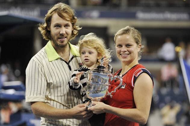 - NEW YORK, USA : Belgian tennis player Kim Clijsters poses with her husband Brian Lynch, their daughter Jada Ellie Lynch and the trophy during the ceremony after she won 7-5, 6-3 the US Open final match against Caroline Wozniaki of Denmark, at the US Open Grand Slam Tennis tournament, at Flushing Meadows, in New York, Sunday 13 September 2009. Clijsters won a Grand Slam title just one month after her coming back to competition, after two years break during wich she became a mother. PHILIPPExBUISSIN  x15359653x