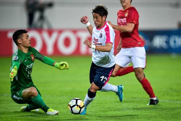 Takaki Fukumitsu of Japan s Cerezo Osaka FC shoots against China s Guangzhou Evergrande Taobao FC in their Group G match during the 2018 AFC Champions League in Guangzhou city, south China s Guangdong province, 17 April 2018. Brazilian striker Alan Carvalho scored twice in the second half to help Guangzhou Evergrande beat the visiting side Cerezo Osaka from Japan 3-1 in a Group G game, final round of the AFC Champions League group stage on Tuesday night. After this game, Guangzhou Evergrande remained unbeaten in this group, earning 12 points and place the first to progress to the knock-out stage of the AFC Champions League, while Buriram United from Thailand managed a 1-0 win over home team Jeju United from South Korea and secured another place in the knock-out stage. Huang Bowen broke the deadlock for Guangzhou Evergrande early in the fifth minute, as the 30-year-old midfielder received the pass from Li Xuepeng, got away from defenders in the penalty area and scored the opening goal. Guangzhou Evergrande beat Cerezo Osaka 3-1 in AFC Champions League  20180417_87991
