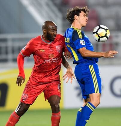 (180418) -- DOHA, April 18, 2018 -- Dame Traore (L) of Al Duhail SC vies for the ball with Sebastian Tagliabue of Al Wahda FSCC during the AFC Champions League Group B soccer match between Qatar s AL Duhail SC and UAE s Al Wahda FSCC at Abdullah bin Khalifa Stadium in Doha, Qatar, April 17, 2018. Al Duhail won 1-0. ) (SP)QATAR-DOHA-SOCCER-AFC CHAMPIONS Nikku 