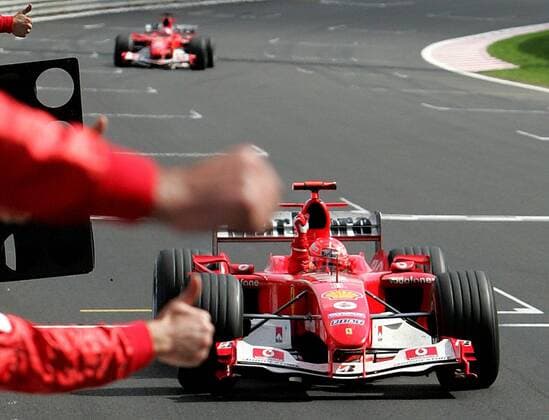 BRU455 - - FRANCORCHAMPS, BELGIUM : German Michael Schumacher celebrates on the finish line of the Belgian Formula One Grand Prix, Sunday 29 August 2004, on the race track of Spa-Francorchamps. Finnish Kimi Raikkonen won the race and Michael Schumacher got World Champion for the 7th time. POOL-FRANCOISxLENOIR  x2141461x