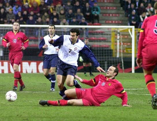 CHAR006 - - Charleroi ,Belgium : Belgian Red Devil Yves Vanderhaeghe (r) try to stop the Portuguese s Luis Figo during the soccer friendly match Belgium vs Portugal tonight Wednesday 23 February 2000 in Charleroi (Belgium) , ahead of the European Soccer Championship which will take place in Belgium Netherland in June . (Electronic image). Belga photo Robert Vanden Brugge vdb ROBERTxVANDENxBRUGGE  x443693x