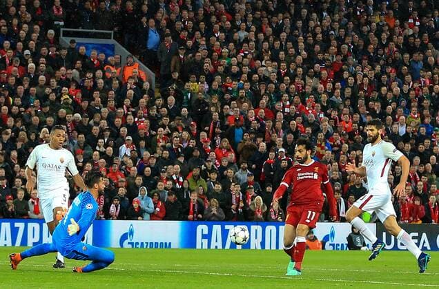 24th April 2018, Anfield, Liverpool, England; UEFA Champions League football, semi final, 1st leg, Liverpool versus AS Roma; Mohamed Salah of Liverpool beats Alisson Becker, Roma goalkeeper, to score his second goal of the match  ActionPlus12016822