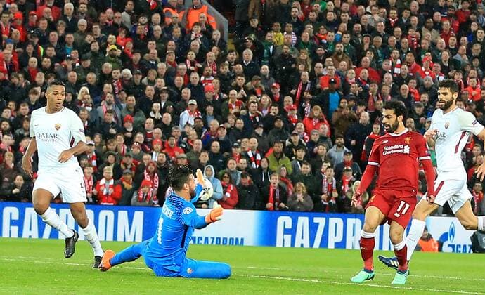 24th April 2018, Anfield, Liverpool, England; UEFA Champions League football, semi final, 1st leg, Liverpool versus AS Roma; Mohamed Salah of Liverpool beats Alisson Becker, Roma goalkeeper, to score his second goal of the match  ActionPlus12016823