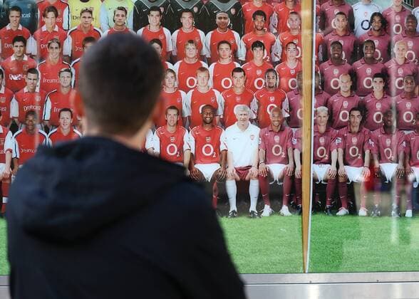 26th April 2018, Emirates Stadium, London, England; UEFA Europa League football, semi final, 1st leg, Arsenal versus Atletico Madrid; Arsenal fan looking at the Arsenal historical timeline wall featuring Arsenal manager Arsene Wenger outside Emirates Stadium  ActionPlus12017158