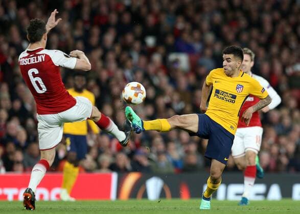 26th April 2018, Emirates Stadium, London, England; UEFA Europa League football, semi final, 1st leg, Arsenal versus Atletico Madrid; Angel Correa of Atletico Madrid chips the ball over Laurent Koscielny of Arsenal  ActionPlus12017278