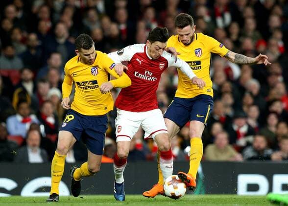 26th April 2018, Emirates Stadium, London, England; UEFA Europa League football, semi final, 1st leg, Arsenal versus Atletico Madrid; Lucas Hernandez and Saul Niguez of Atletico Madrid put pressure on Aaron Ramsey of Arsenal  ActionPlus12017324