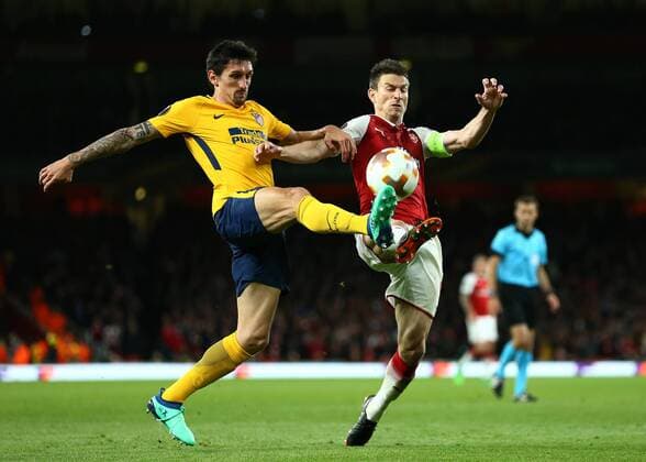 26th April 2018, Emirates Stadium, London, England; UEFA Europa League football, semi final, 1st leg, Arsenal versus Atletico Madrid; Laurent Koscielny of Arsenal and Stefan Savic of Atletico Madrid compete for the ball  ActionPlus12017328